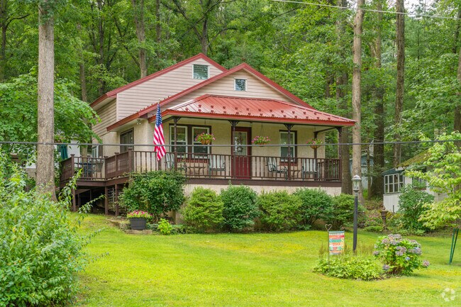 In Barry, single family homes like this bungalow has colorful tin roofing and a front porch in Moon Lake.
