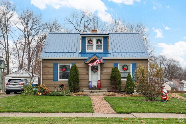 A Cape Cod with a neatly lined brick path is decorated for Christmas, in Warren.