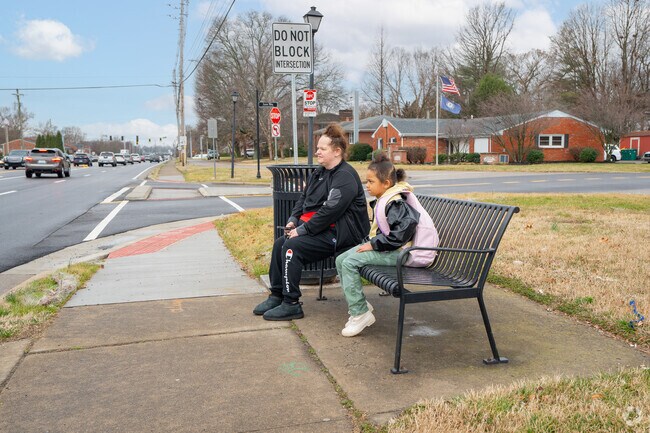 There are multiple bus stops along busy Westport Road bordering Woodlawn.