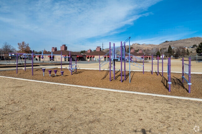 A large playground in the back of Jerry Whitehead Elementary School.