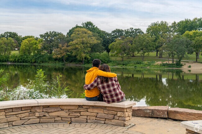 A couple enjoys an afternoon by the Fox River at Island Park in the Pigeon Hill area of Aurora.