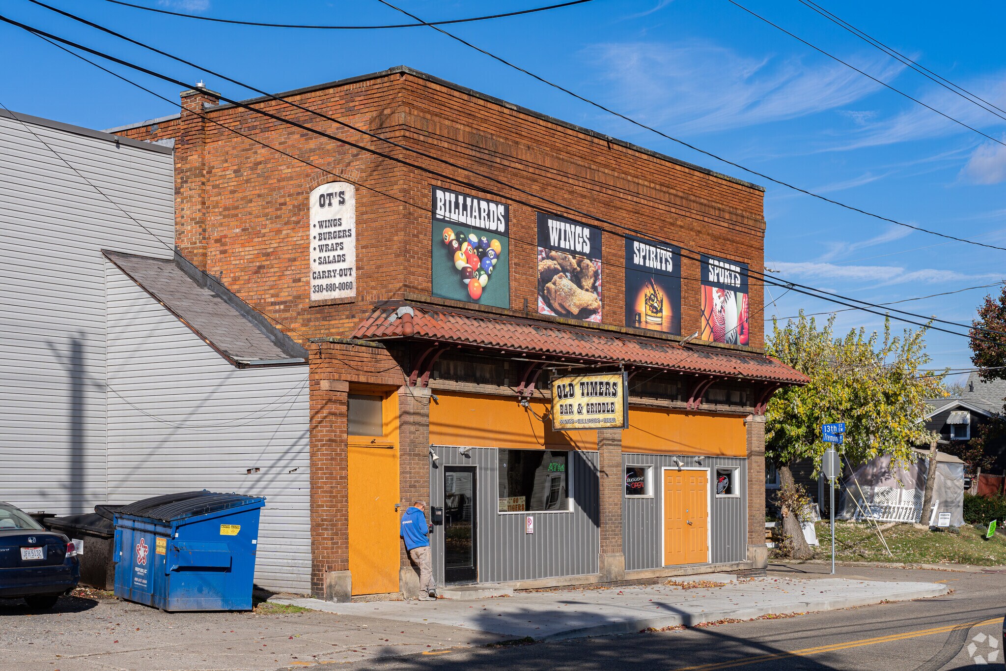 A resident stands outside the Old Timers Bar & Griddle in West Massillon.