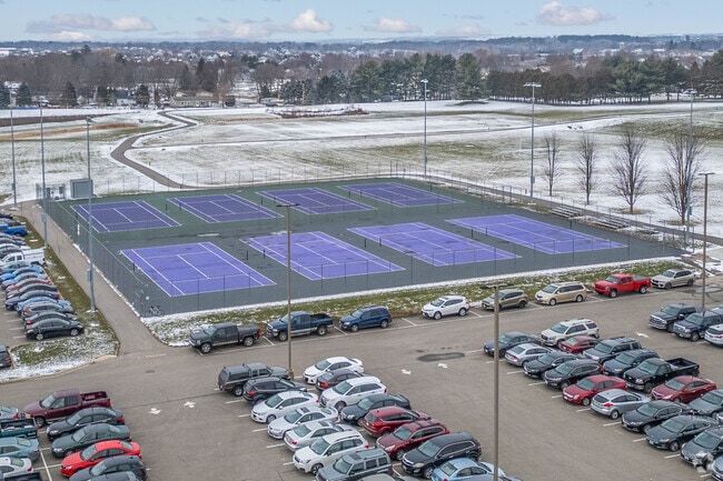 There are tennis courts next to the Deforest Area High School parking lot.