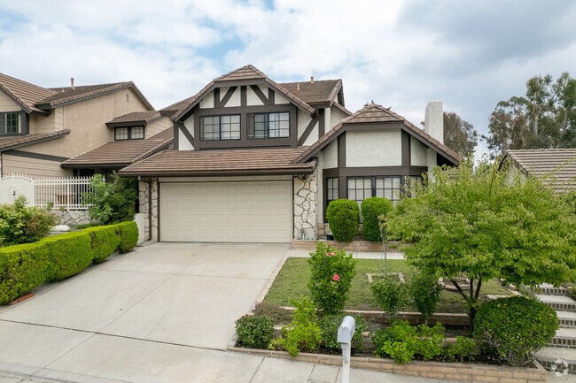 This Tudor-style 2-car garage home in Coyote Hills has lovely landscaping and is very cozy.