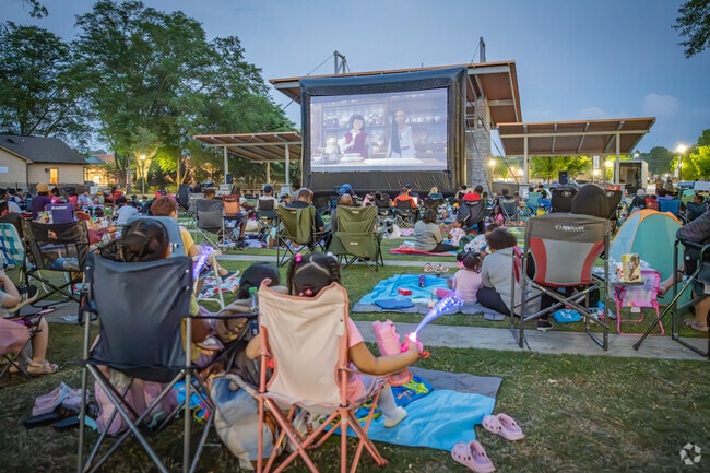 Local residents and families enjoy a free movie at Grayson Park.