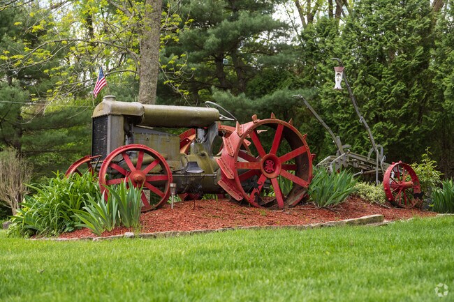 Charming and unique Lippitt Estates lawns showcase character with classic tractors and decorative touches throughout the neighborhood.