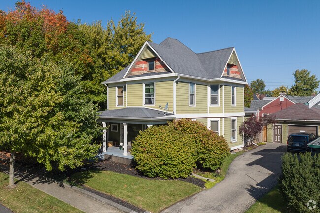 An older traditional home with shaded porch common to the downtown Fortville.