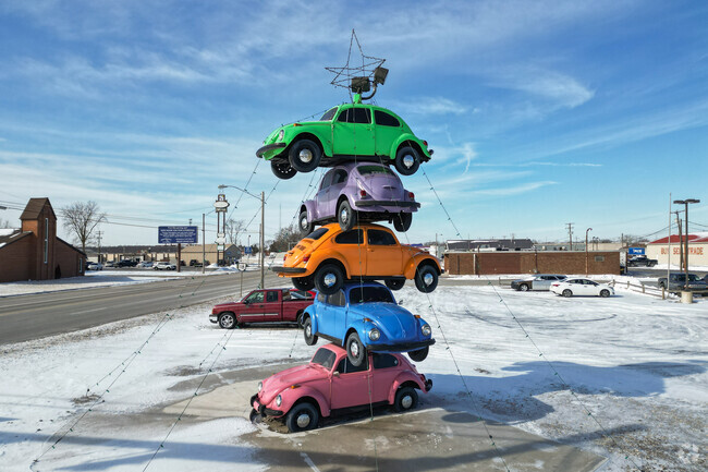 These stacked 60's VW bugs are a promotional sign for Pack Rat's Pawn Shop.