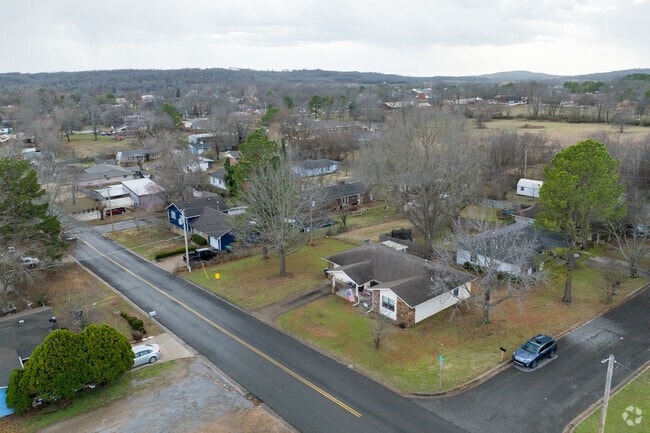 An aerial view of homes in Tahlequah showcases a picturesque spread of residences, nestled among the scenic landscape.