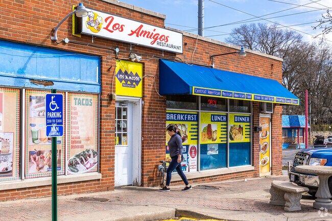 Locals grab lunch at Los Amigos, ordering favorites like steak tacos, tamales, and pupusas.