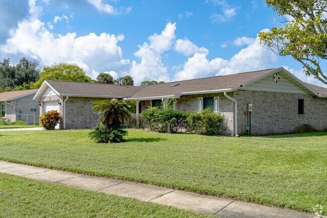 This Georgetowne home has a spacious yard and lush grass.