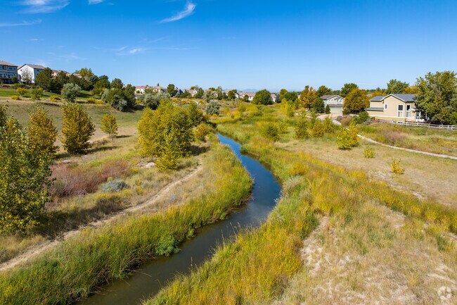 A scenic creek runs along the trail at Creekside Park at the Farm in The Farm-Arapahoe.
