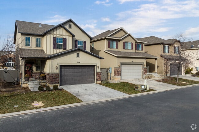 A row of two story homes in Thanksgiving line a quiet neighborhood street.
