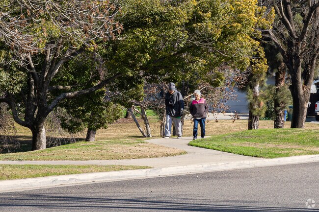 A Tulare couple enjoys a morning walk around Cypress Park’s paved pathways.