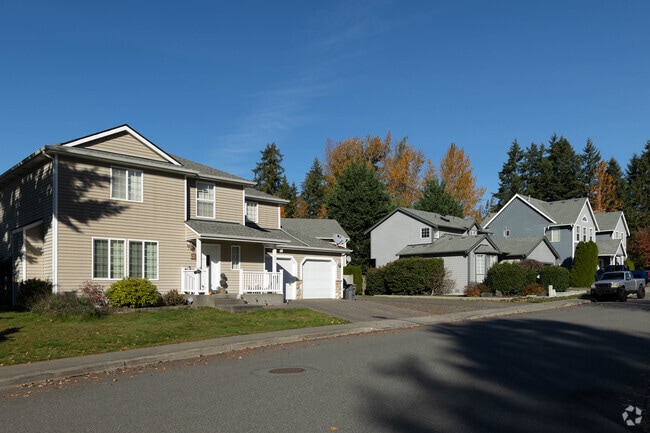 Some two-story homes in West Renton Highlands use wood siding and have two car garages.