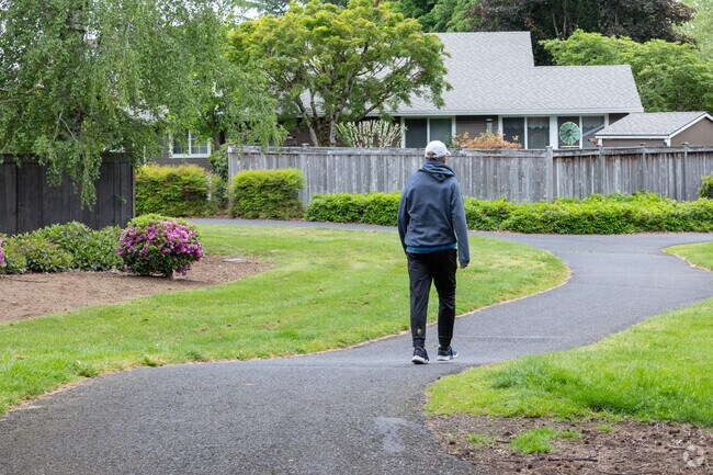 Pedestrians walk along trails on SE 160th Avenue in Cascade Park.