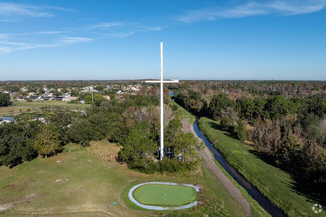 A significant-sized cross captures attention when driving by New Beginnings Academy.