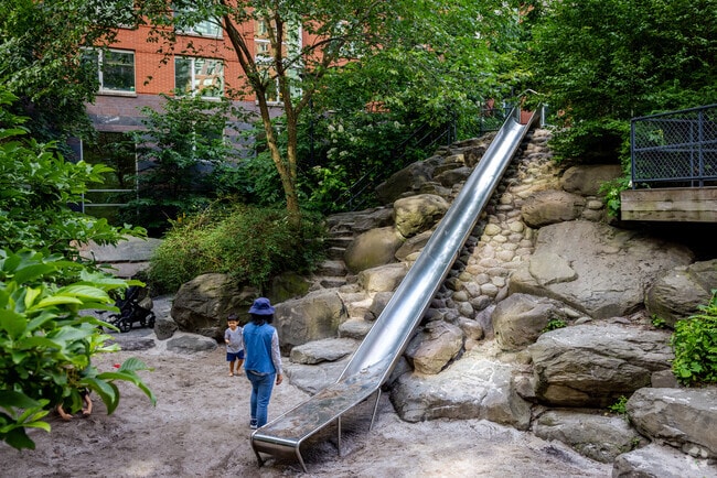 Kids and parents enjoy the long slide at Teardrop Park.