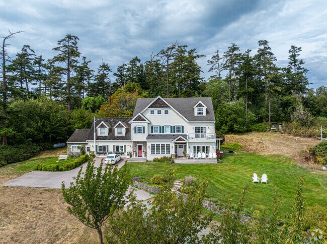 This stunning two story home has a colonial style feel with beautiful window shutters.