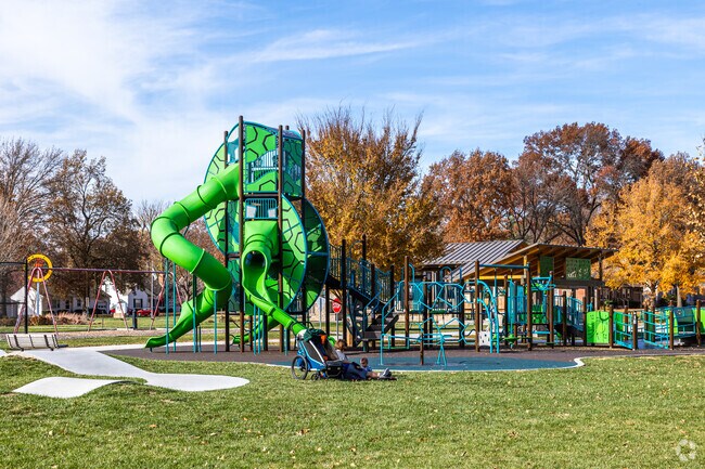 Residents enjoy a nice day at R Park while the kids play on the huge playground.