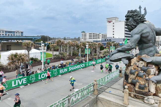 Spectators line the streets of the Oceanfront, cheering runners on to the finish line.