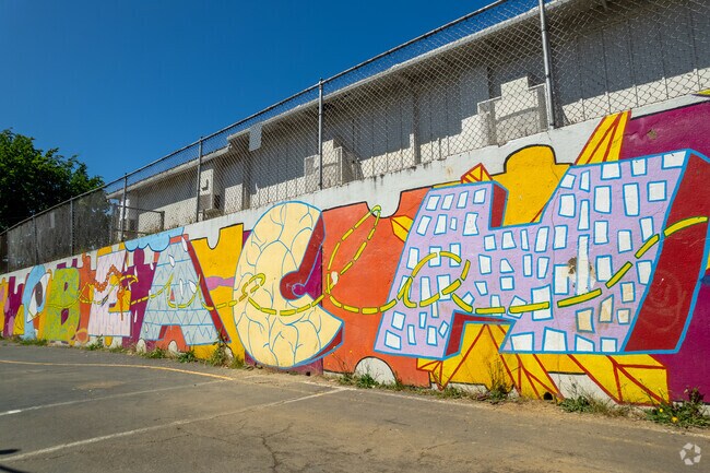 A colorful mural brightens the playground wall at Beach Elementary School in Portland, Oregon.