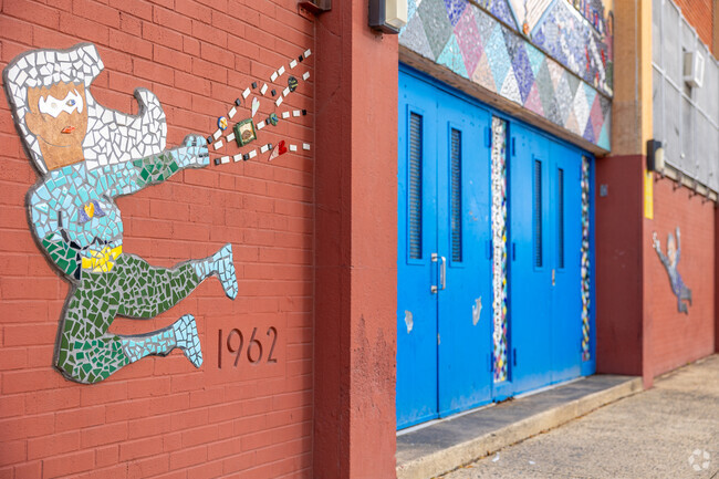 Find mosaic murals along the entrance of Add B. Anderson School .