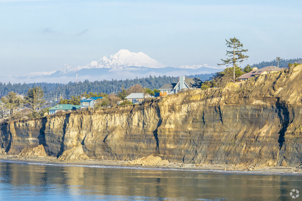 Mt Rainier sits behind West Beach County Park in the Sierra area of Whidbey Island WA.