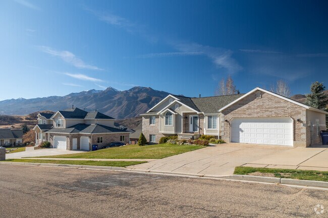 Mountain Green homes often feature stonework and neutral exteriors.