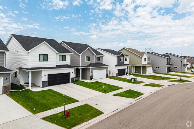Aerial views reveal neatly arranged rows of homes in Brandt Crossing, amidst green spaces.