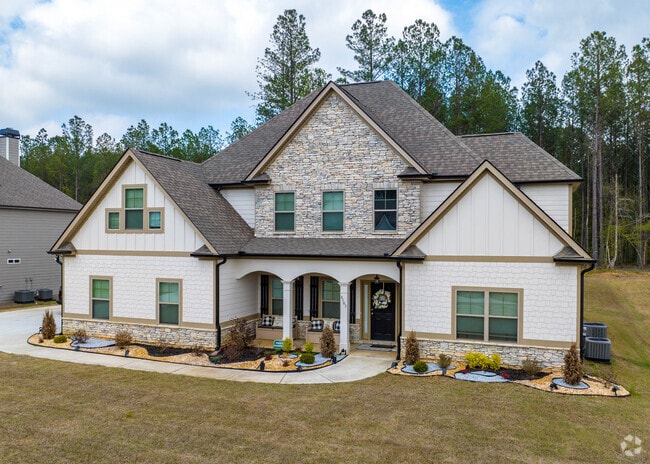 Chattahoochee Hills subdivisions have large craftsman style homes with green landscapes.