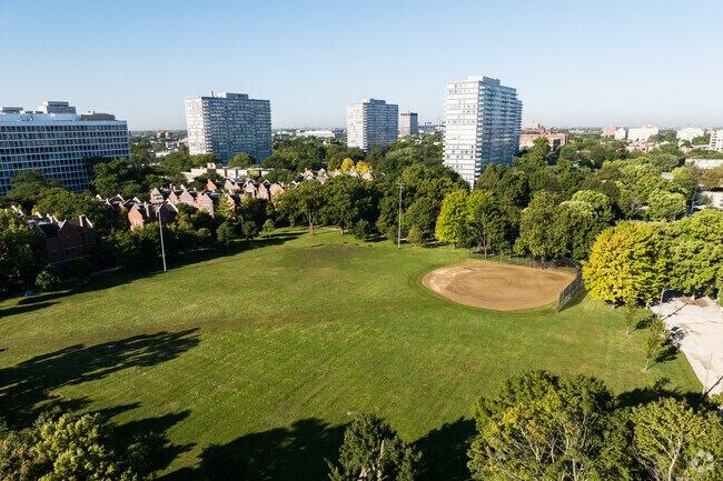 Lake Meadows has a large baseball field surrounded by mature trees.