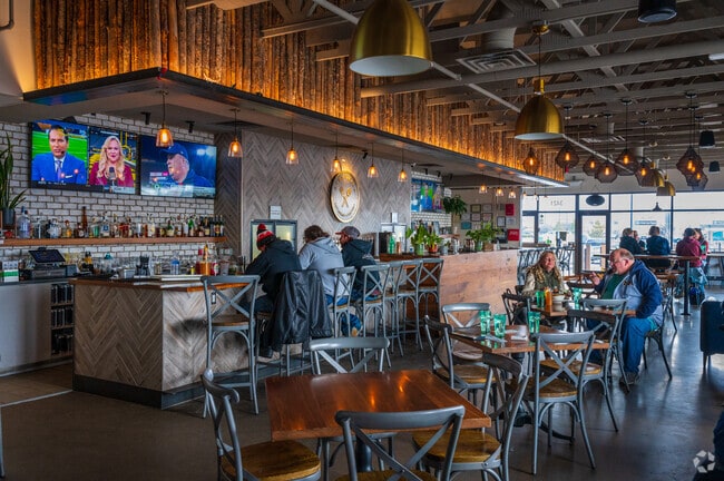 Friends gather at the bar at Sobremesa Brewing on Coors Blvd NW.