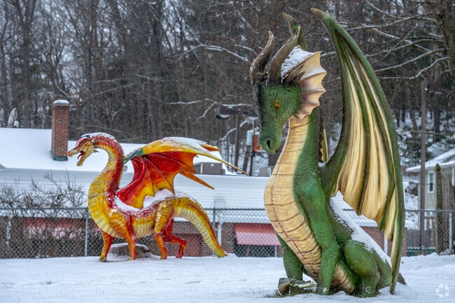 Two dragons sit outside a home in Palmer, Massachusetts.