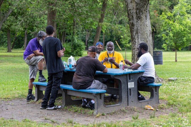 Friends hanging out at Farnham Park playing cards in Parkside.