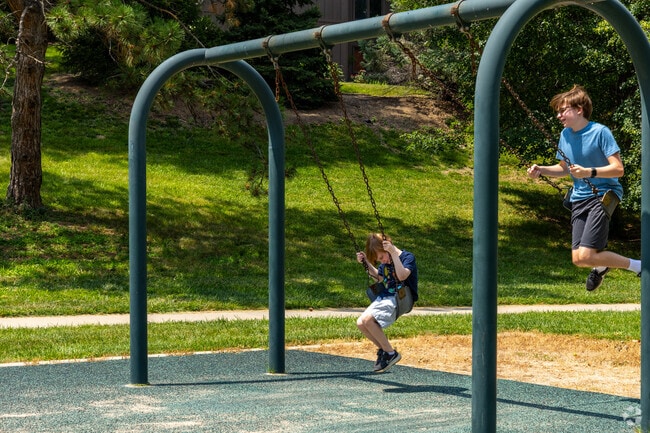 Kids enjoy the swings at Harvey Oaks Park near Crescent Oaks.