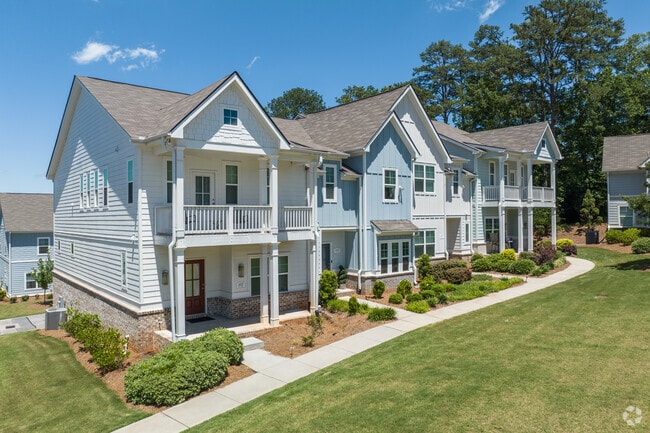 Townhomes with bright facades and fresh landscaping demonstrate the growth of high-end development in Whitlock.