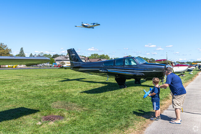 Kids are enthralled by the planes at the Brookeridge Annual Fly/Drive-In in Darien.