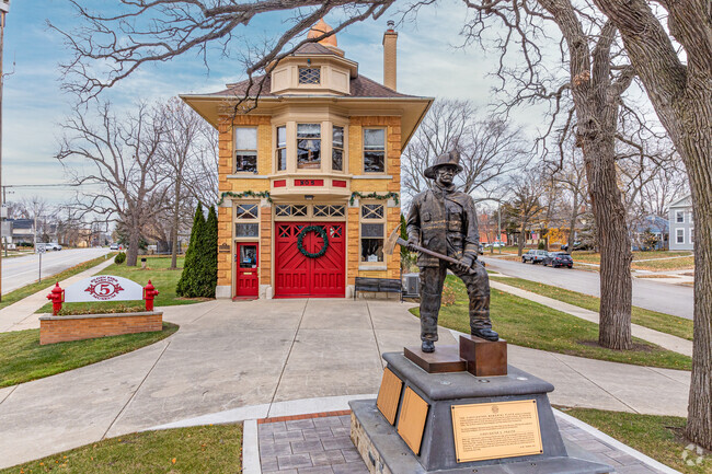 A bronze statue of a fireman proudly welcomes visitors to the Elgin Fire Barn No. 5 Museum.