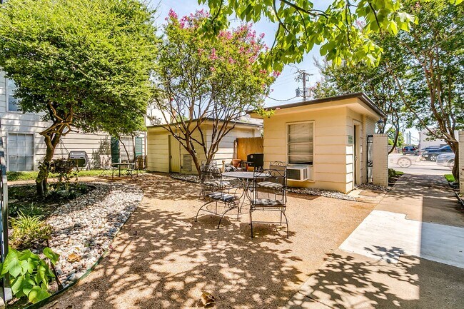 Common interior courtyard with tables and outdoor grill. Laundry room on right.
