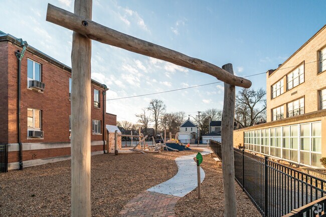 Pope John XXIII School has an outdoor play area between the school buildings.