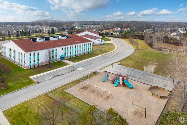 Athletic fields and playground behind Crescent Academy International.