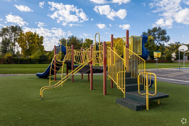 A colorful playground is surrounded by green space at Lincoln Elementary School.
