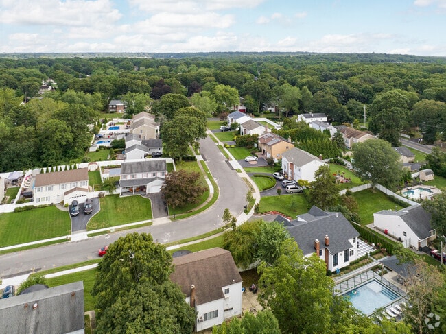 Hauppauge's lush landscape features sidewalks throughout the neighborhood.