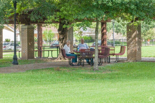 Residents enjoy the shade of mature oak trees in Walnut Park, located in Webster.