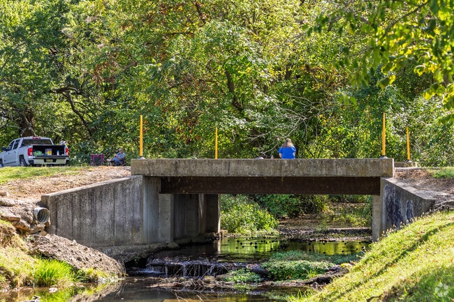 Residents relax along Spring Creek at Marionville City Park.