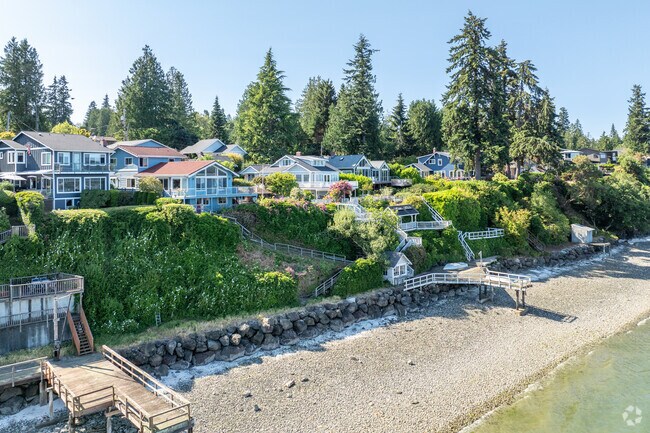 Embrace the coastal allure of private beach waterfront Craftsman homes nestled in Suquamish.
