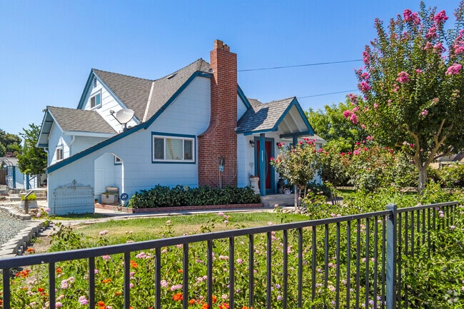 A Tudor style home with colorful landscaping in West Riverbank.