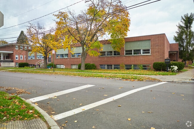 St. John Bosco Schools has large classrooms, a gymnasium, cafeteria, and outdoor play space.