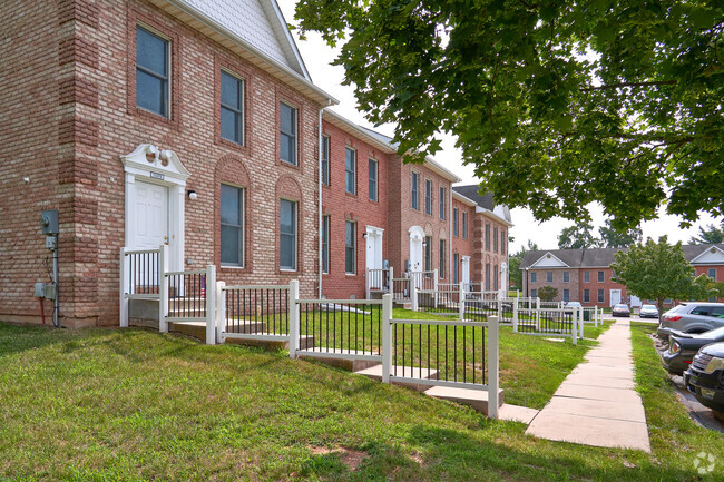 Rows of brick Colonial townhomes line the street in a Robinwood community.